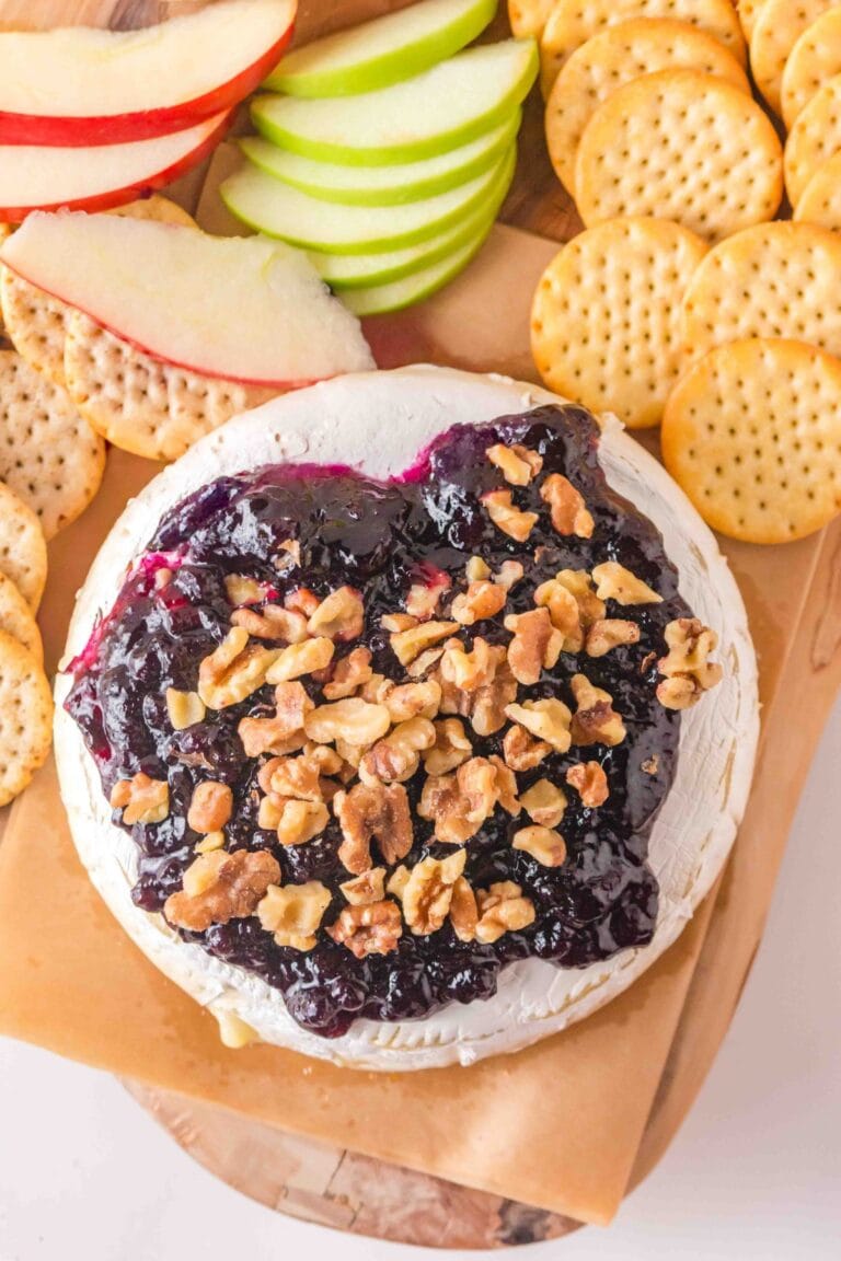 Overhead of Baked Brie Cheese with blueberry preserves.