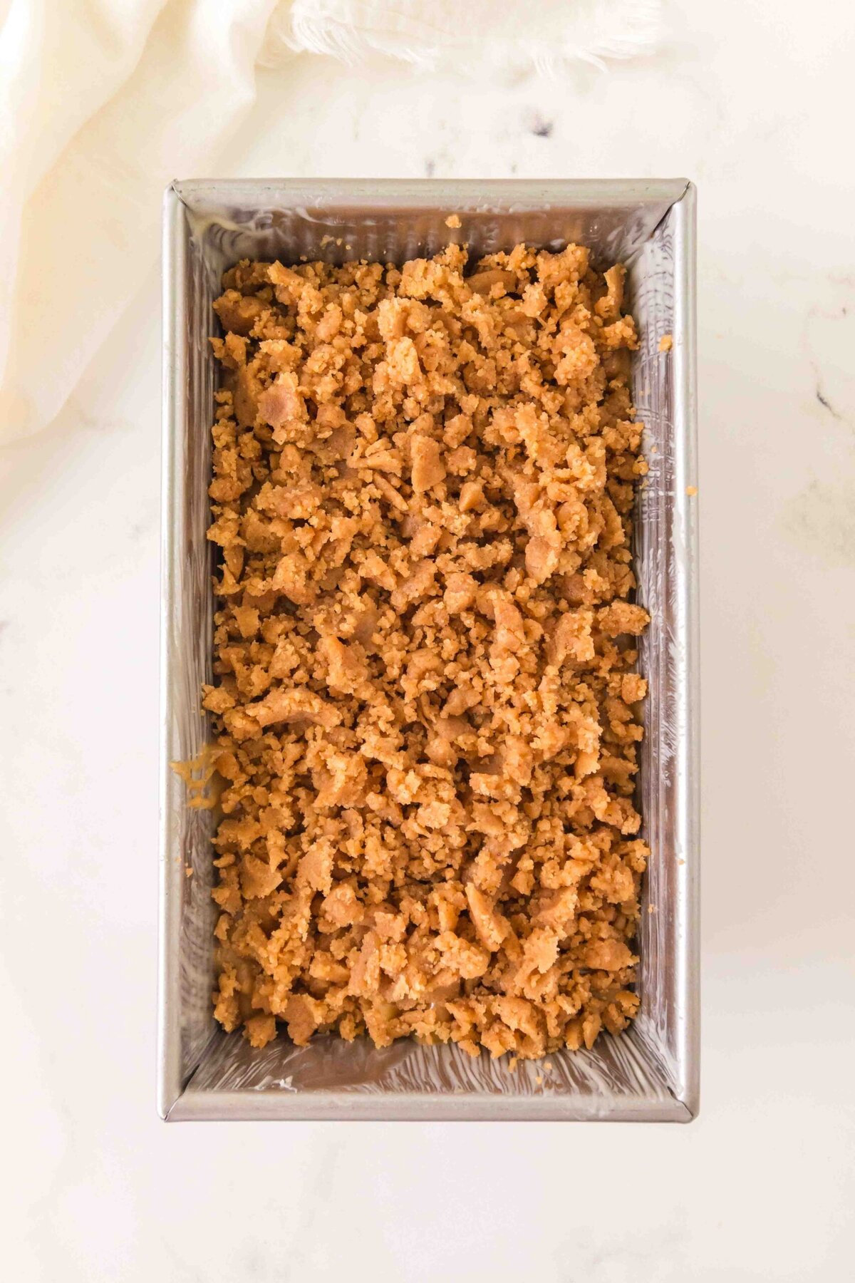 Crumble added to cake pan.