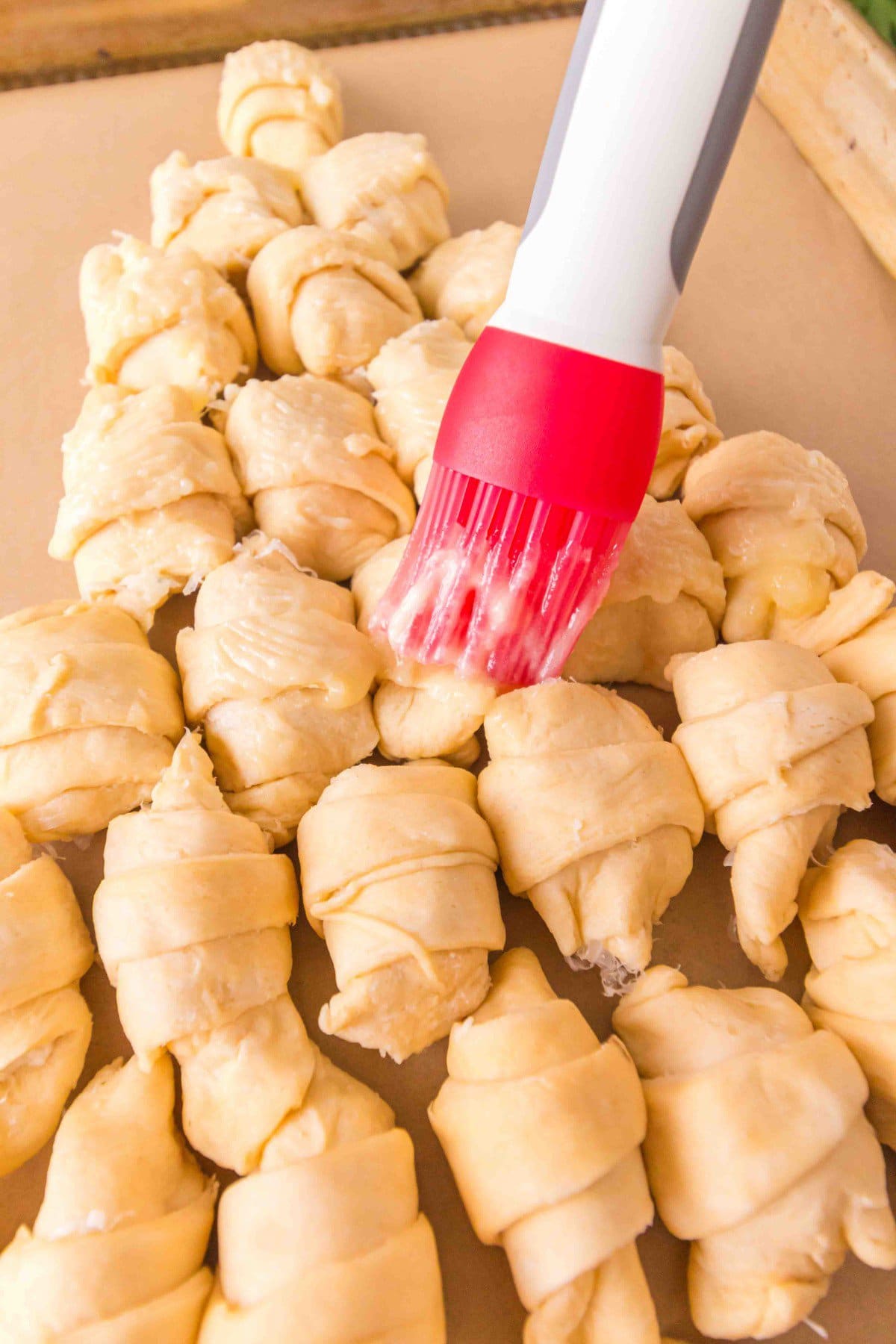 Brushing with butter.