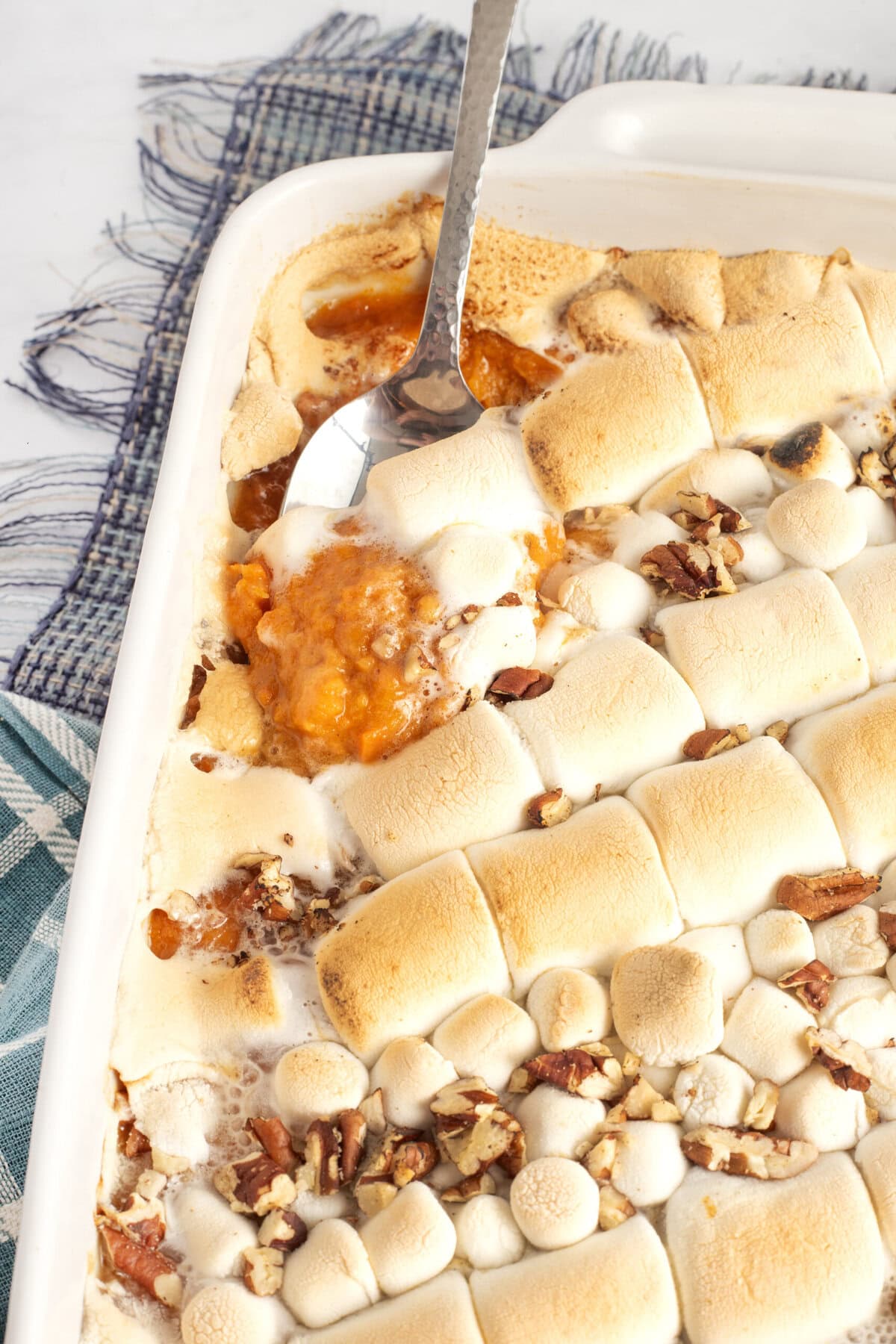 Spooning out the casserole.