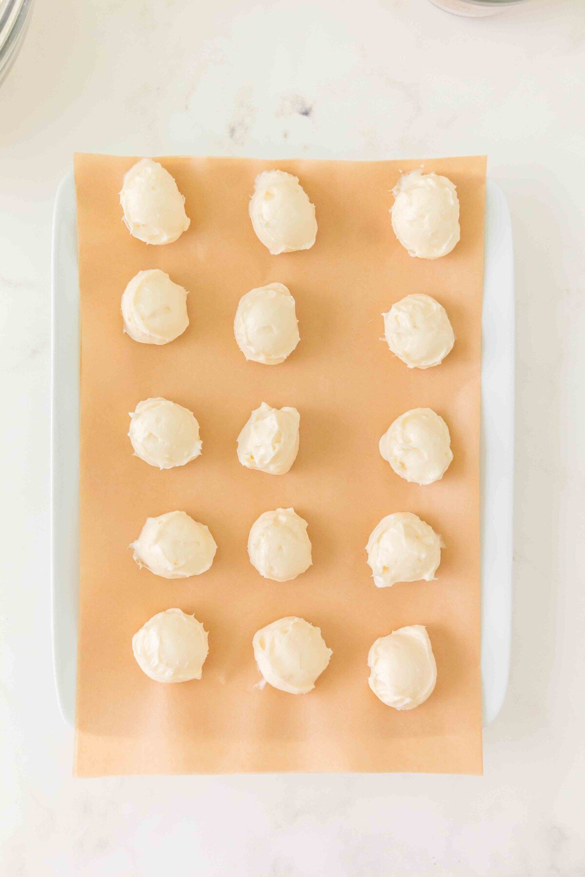 Cheesecake filling on parchment and a baking sheet. 