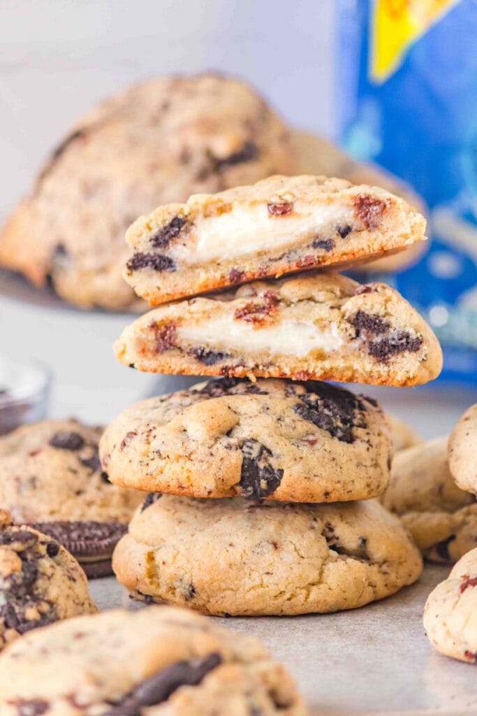 Oreo Cheesecake Cookies cut in half and stacked.