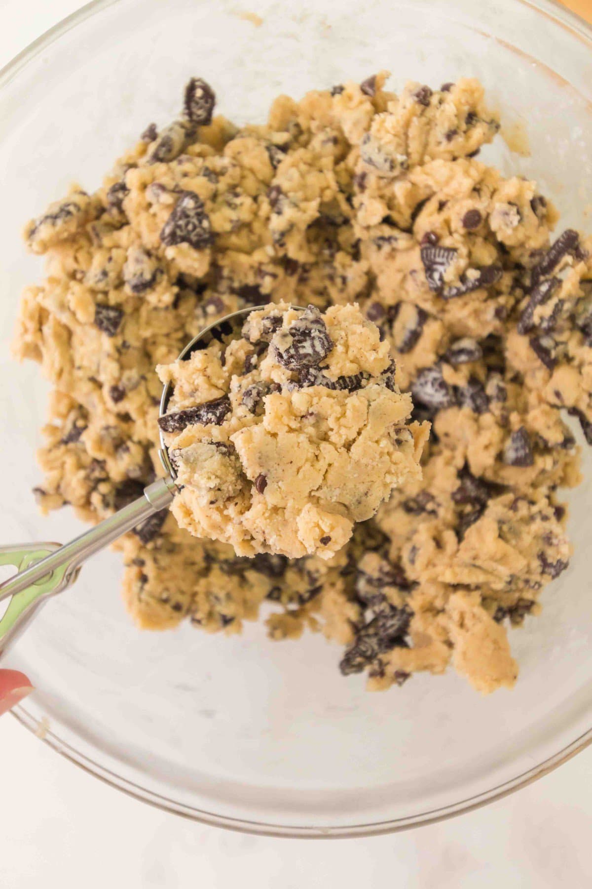 Taking a large scoop of dough. 