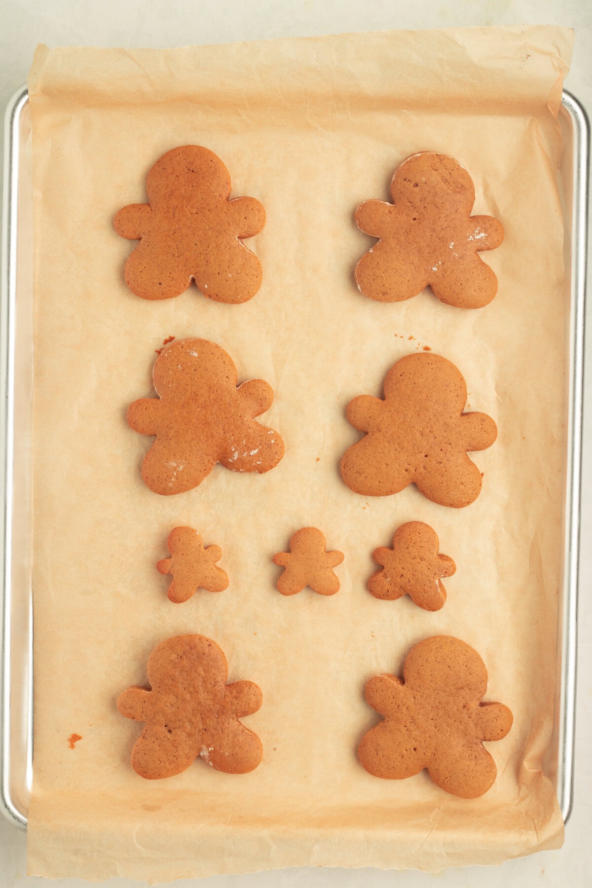 Baked gingerbread men on cookie sheet. 