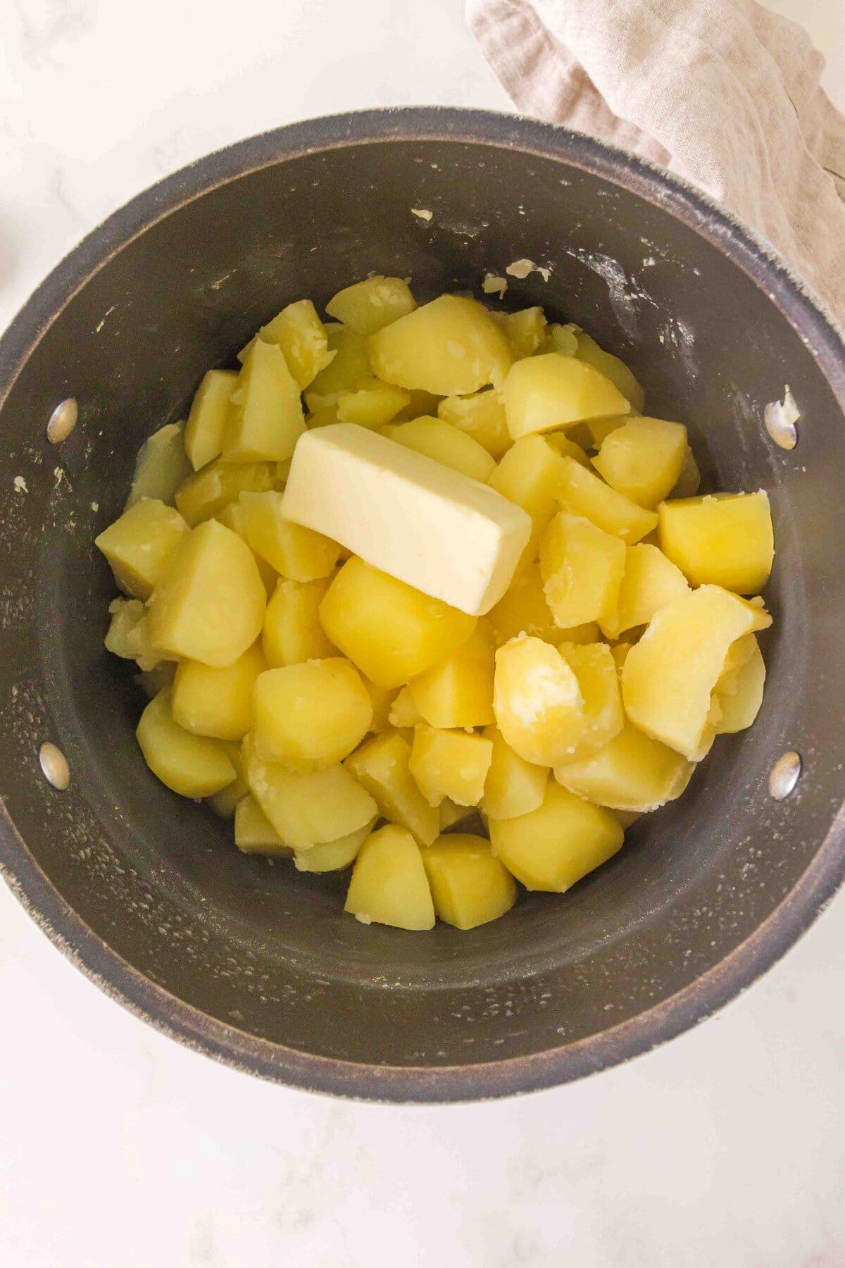 Potatoes and butter in saucepan.