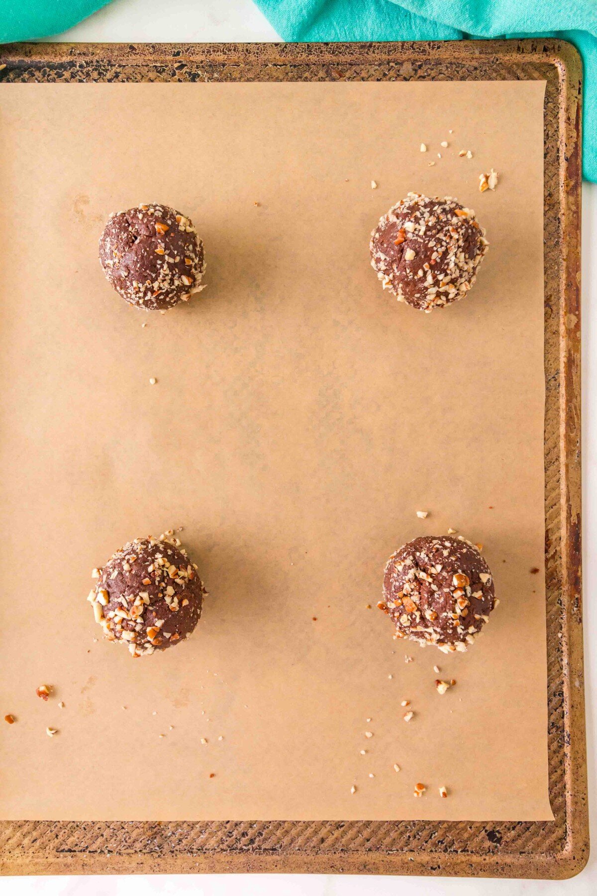 Cookie balls on a baking sheet.