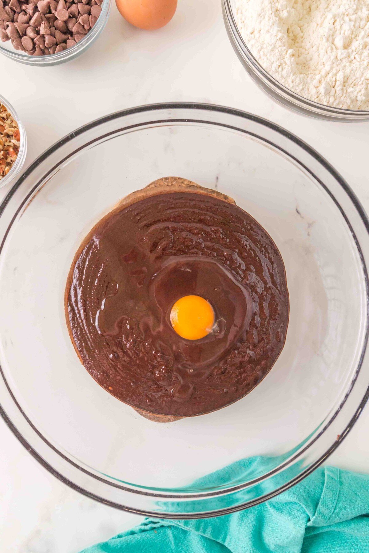 Adding egg to batter.