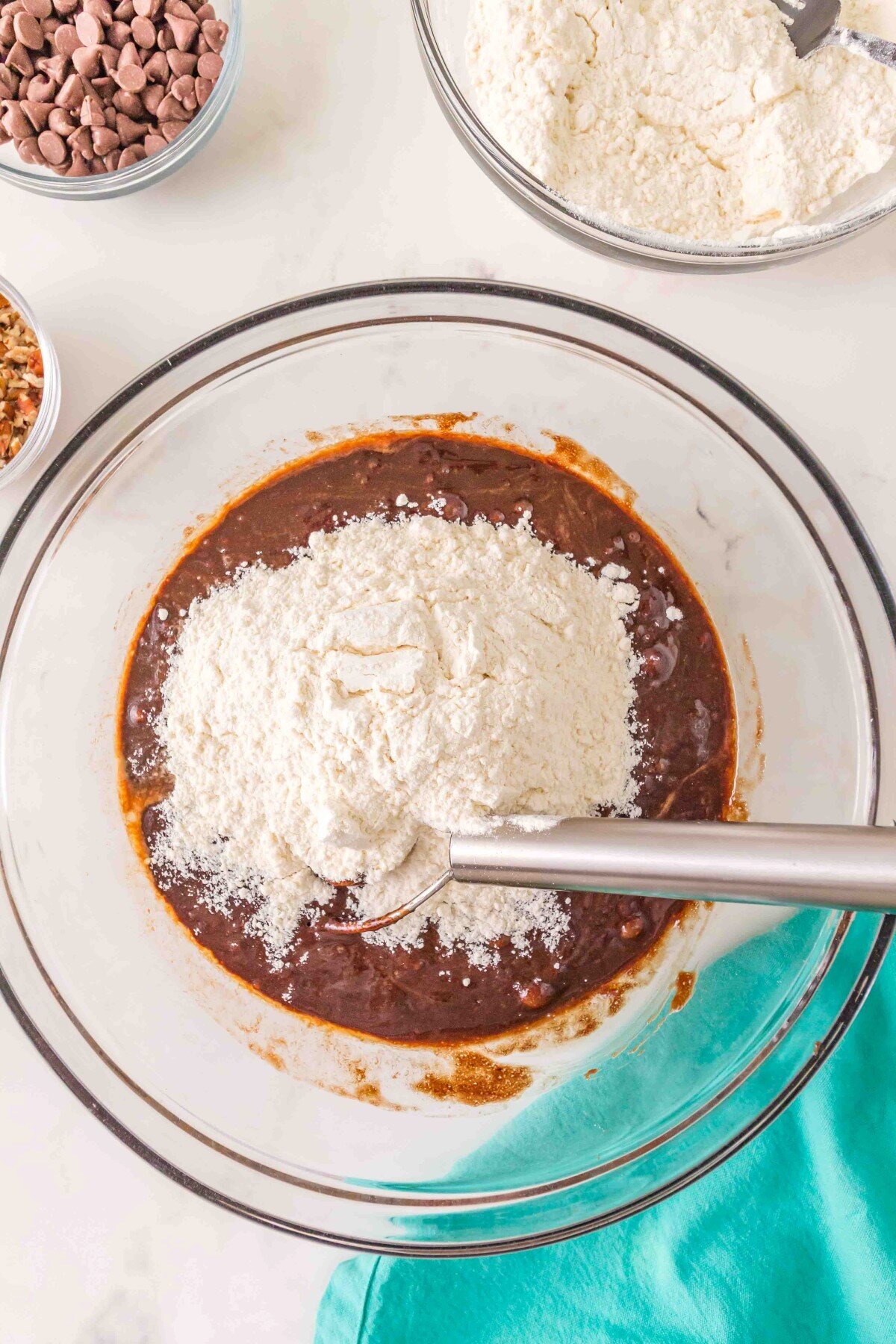 Adding flour to batter.