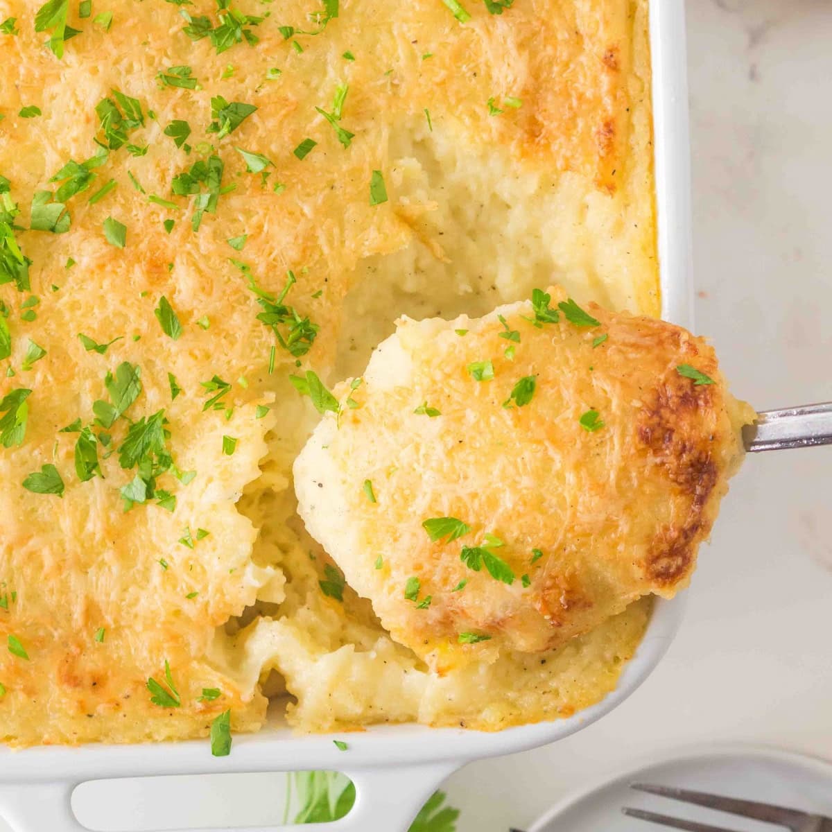 Taking a scoop of potatoes. 