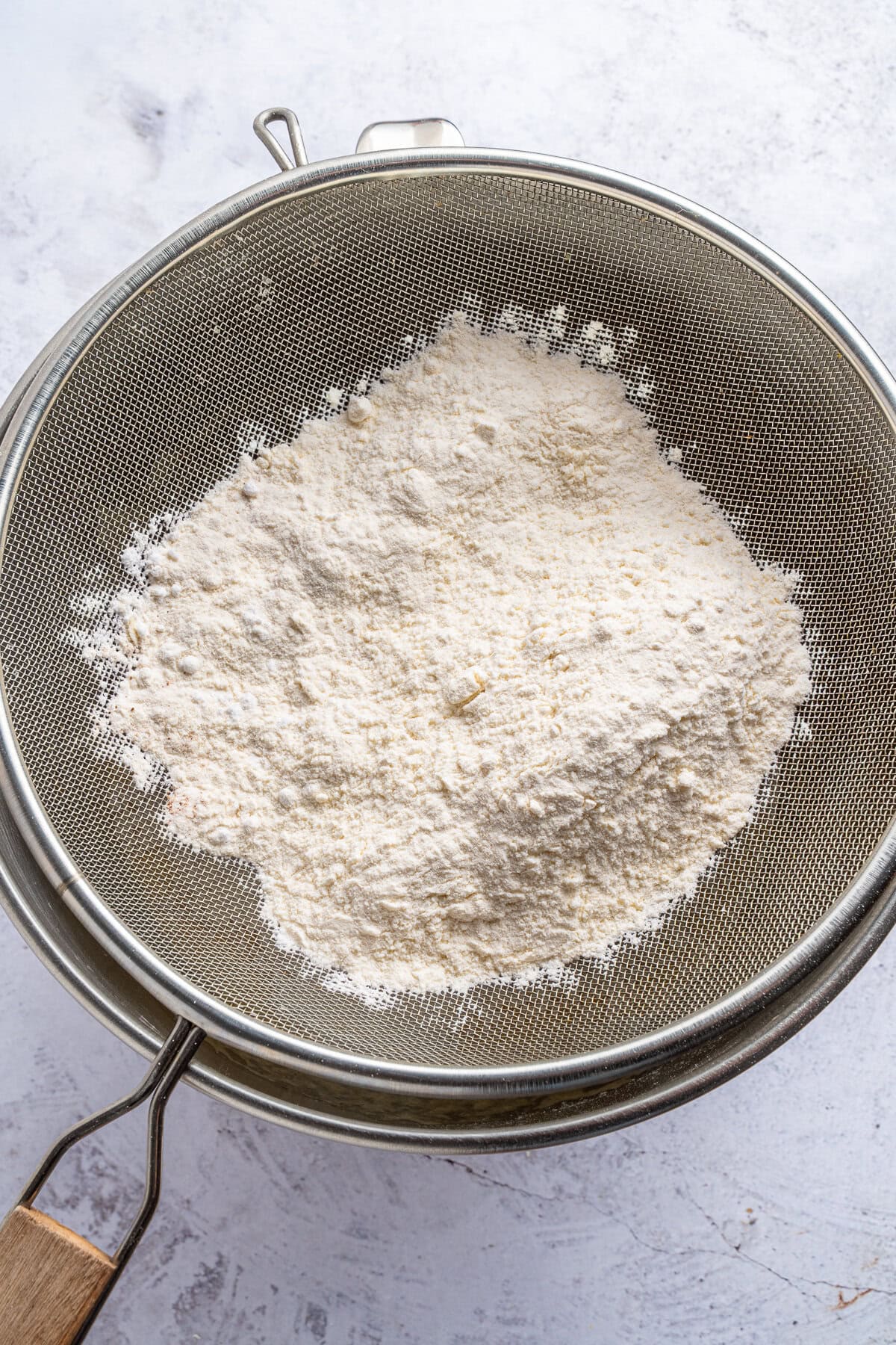 Sifting dry into wet ingredients.