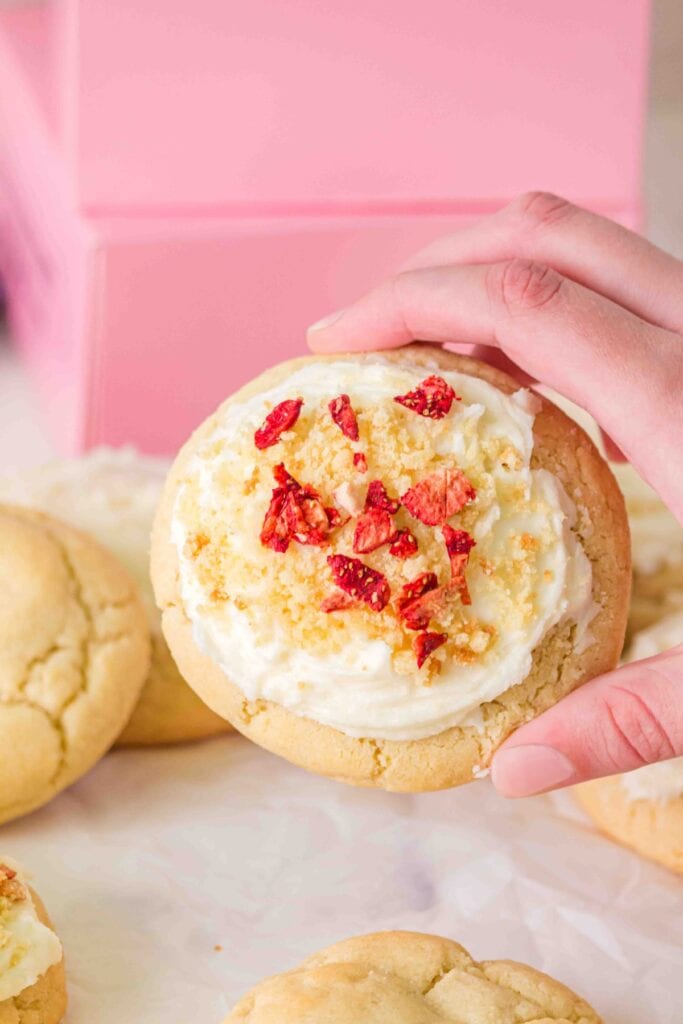 Holding a Crumbl Sugar Cookie.