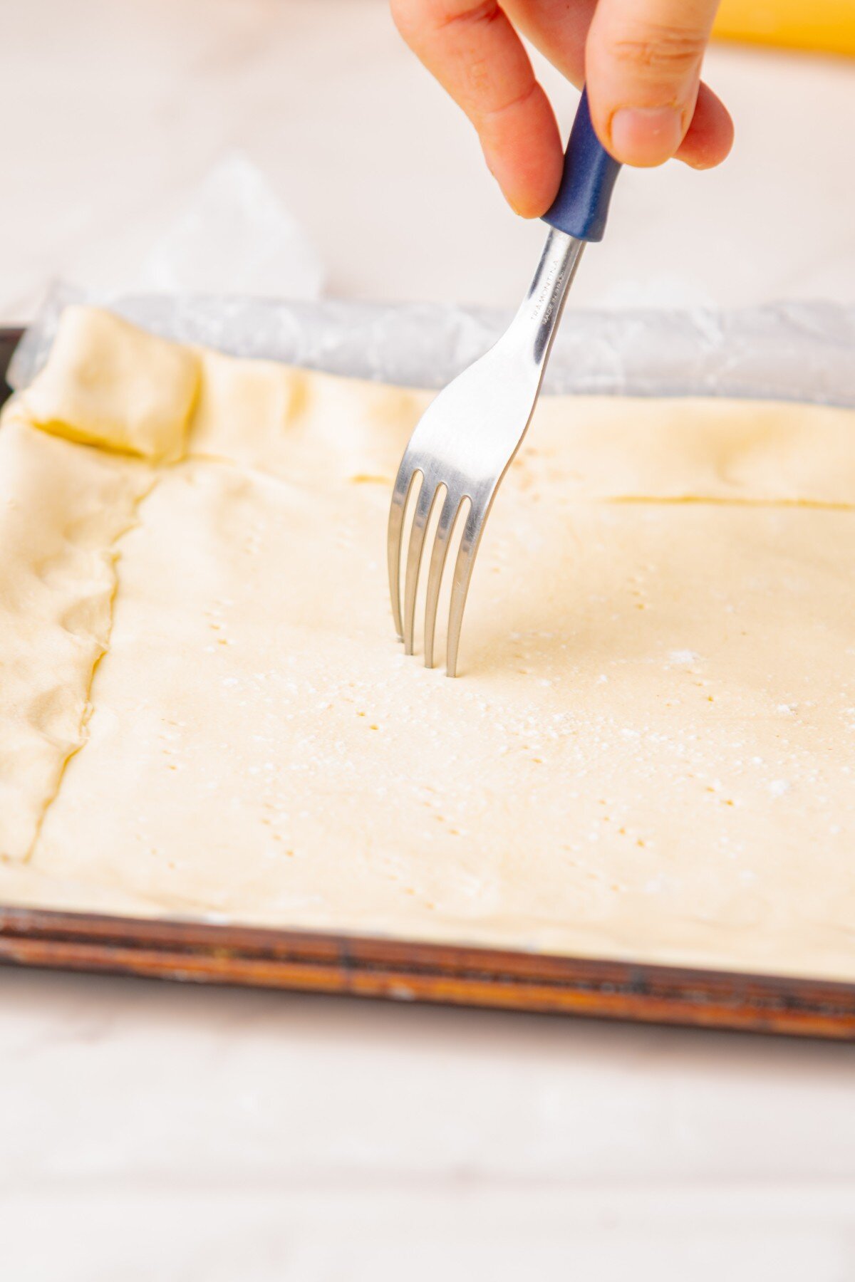 Docking pastry with a fork.