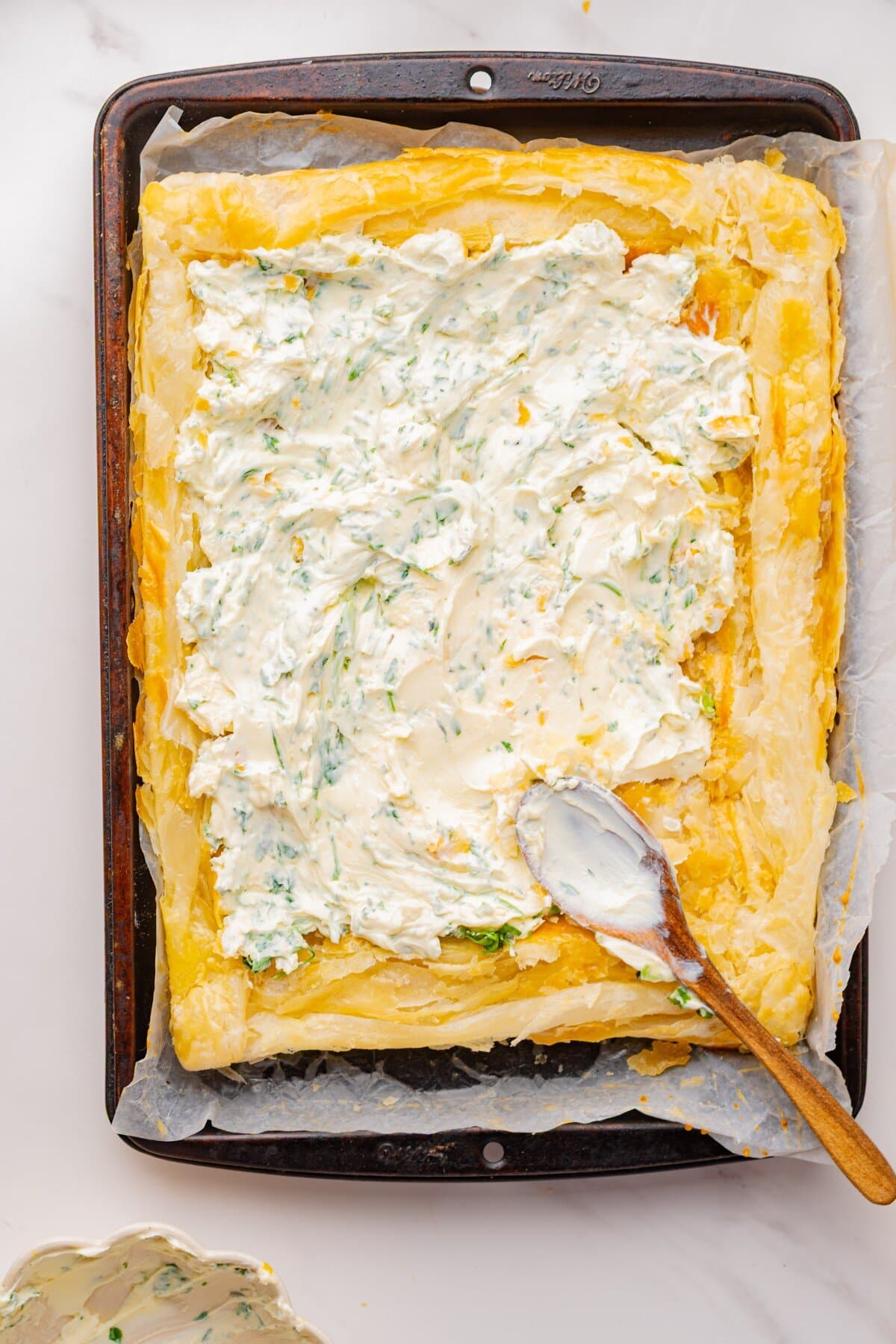 Spreading goat cheese mixture on.