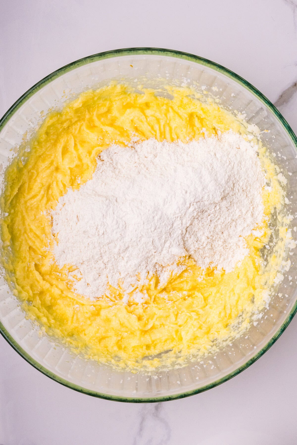 Adding more flour mixture to the batter.