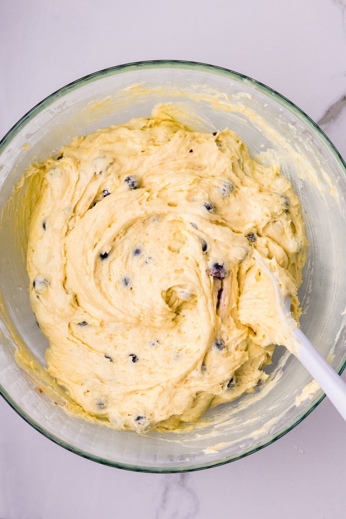 Folding in the blueberries in the batter.