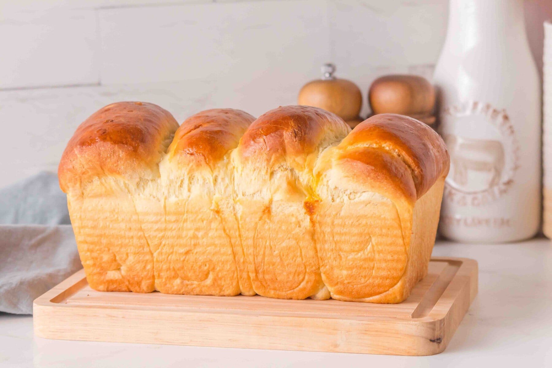 Japanese Milk Bread on a wooden cutting board.