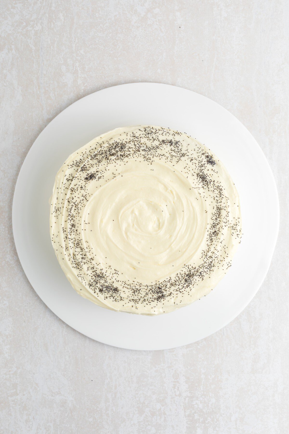 Poppy seeds added to top of cake.