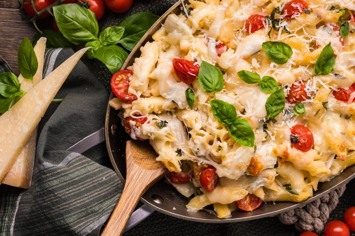 With a wooden spoon in the dish.