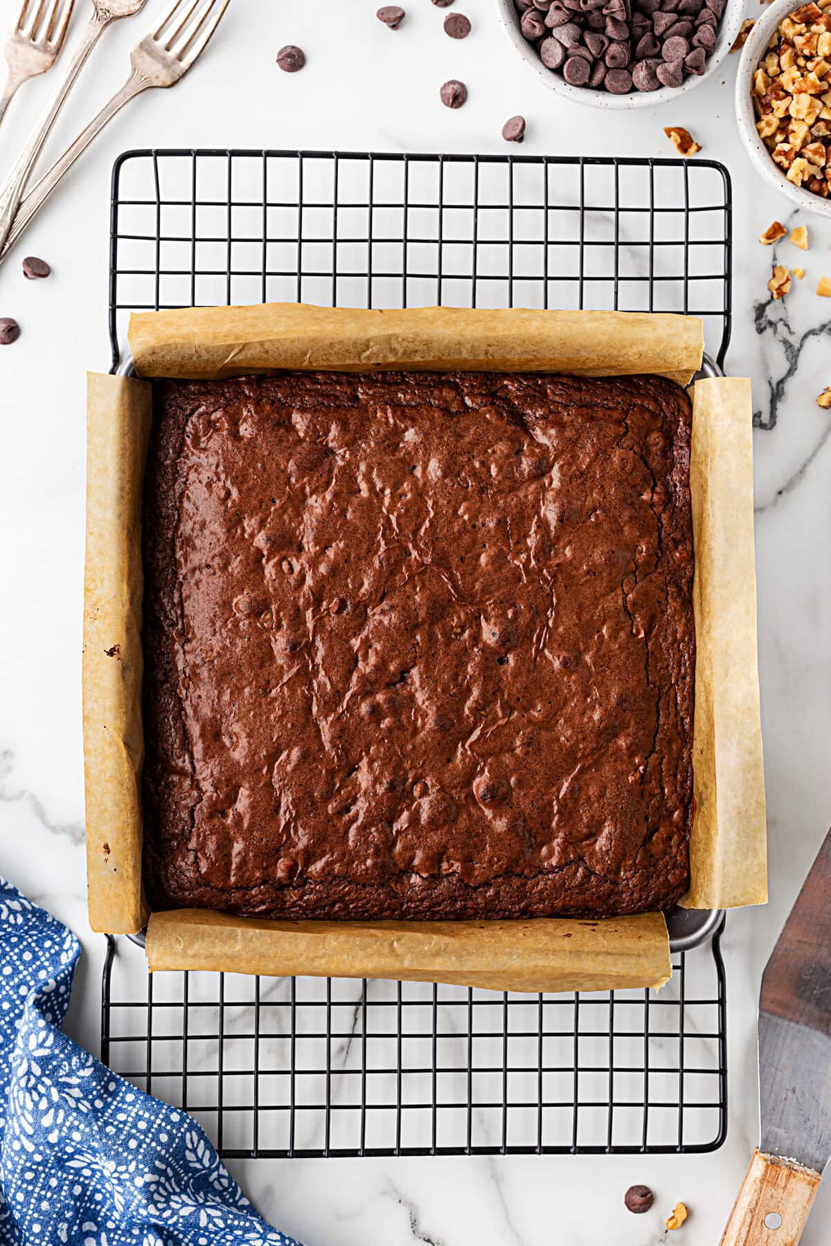 Cooked brownies in the pan cooling on a cooling rack.