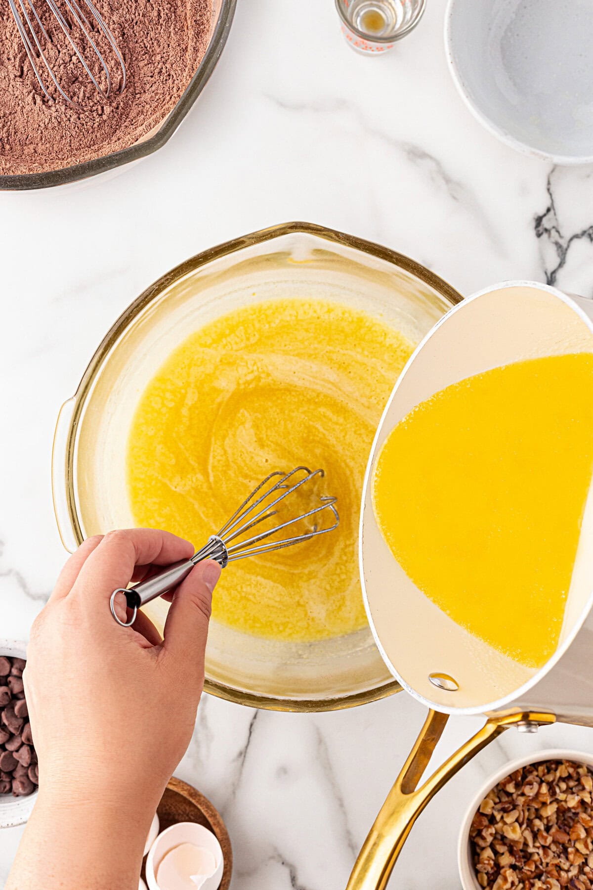 Adding melted butter to the mixture.