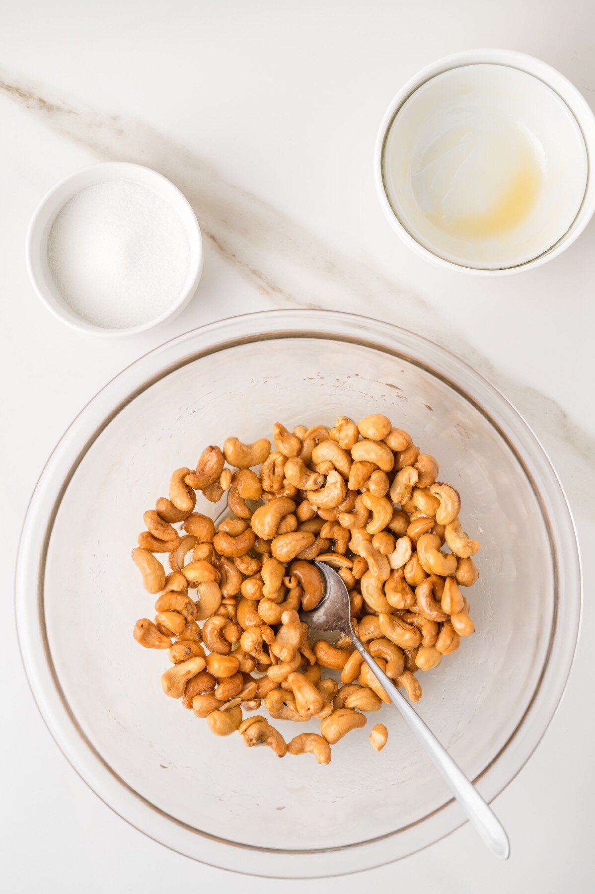 Mixing cashews with honey butter. 