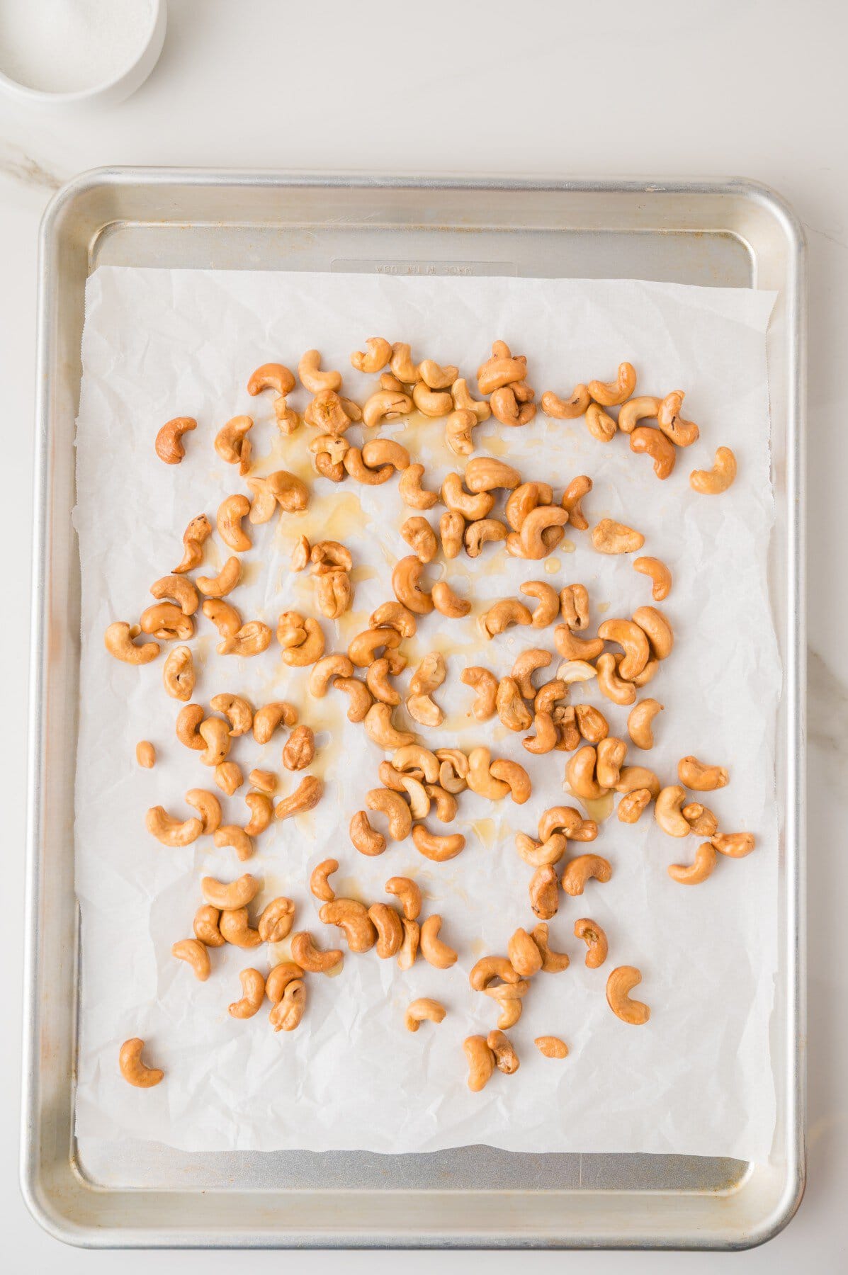Flavored cashews on a baking sheet. 