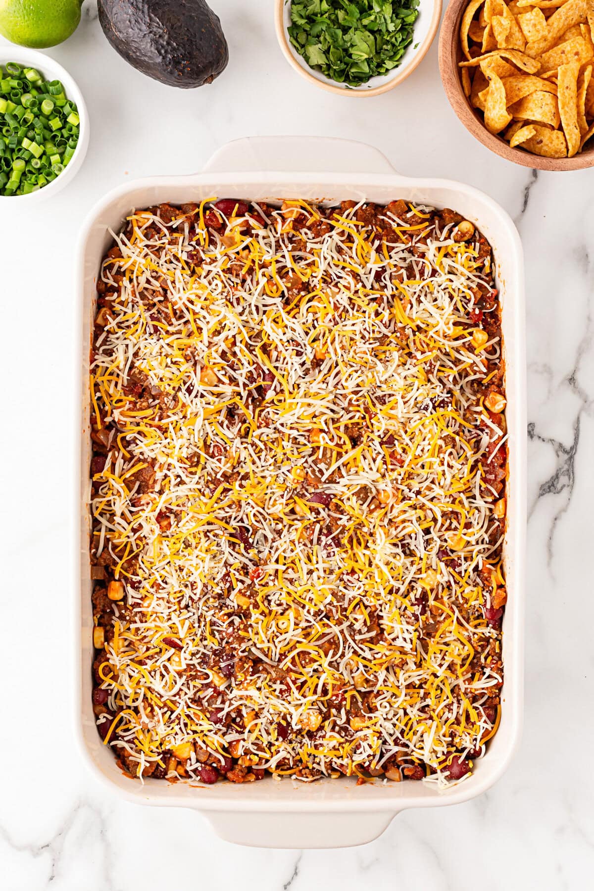 Additional cheese on top of the beef.