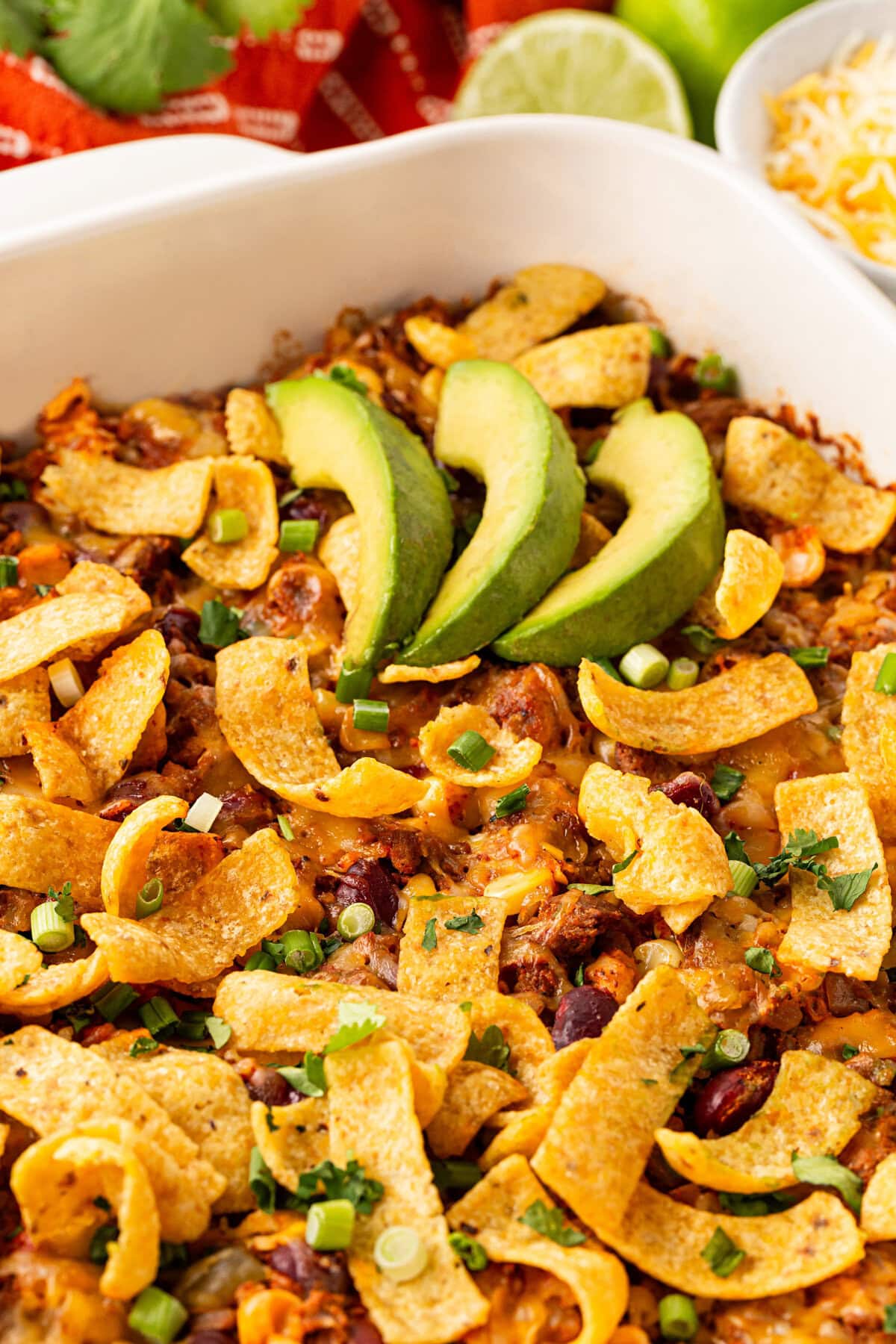 Baked Frito pie with garnishes.