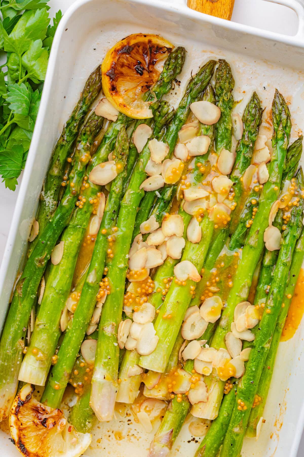 Finished roasted asparagus in a casserole dish. 