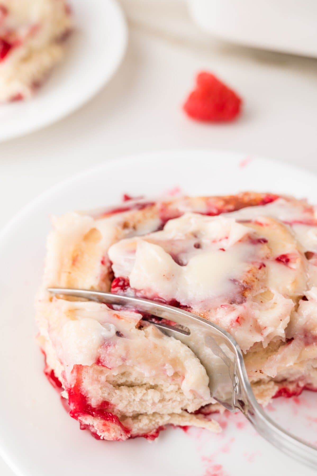 Cutting in to a roll with a fork. 