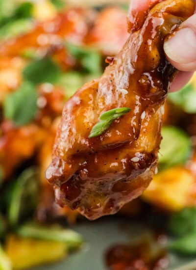 Holding a chicken wing.