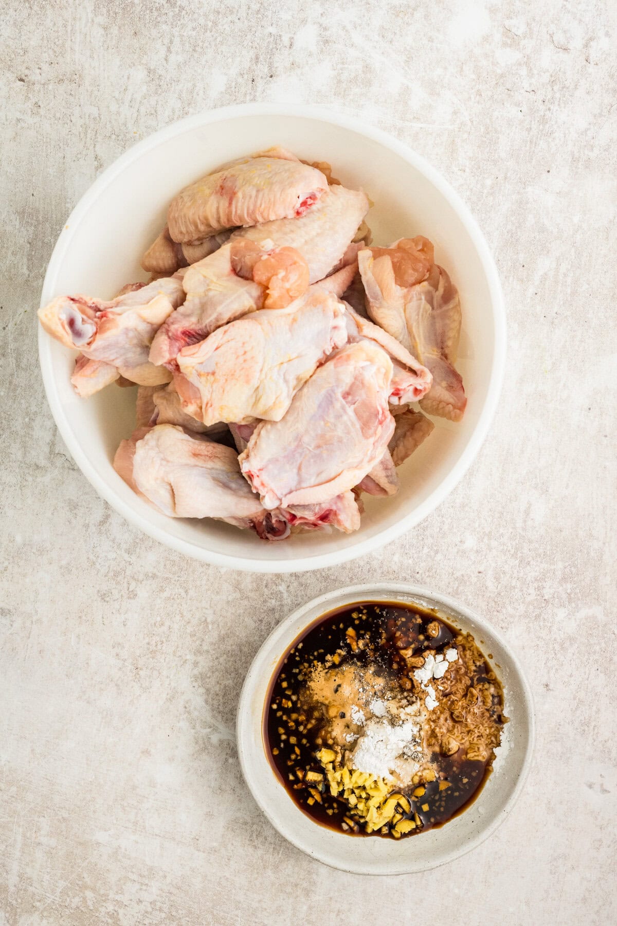 Wings in a bowl, sauce in a bowl. 