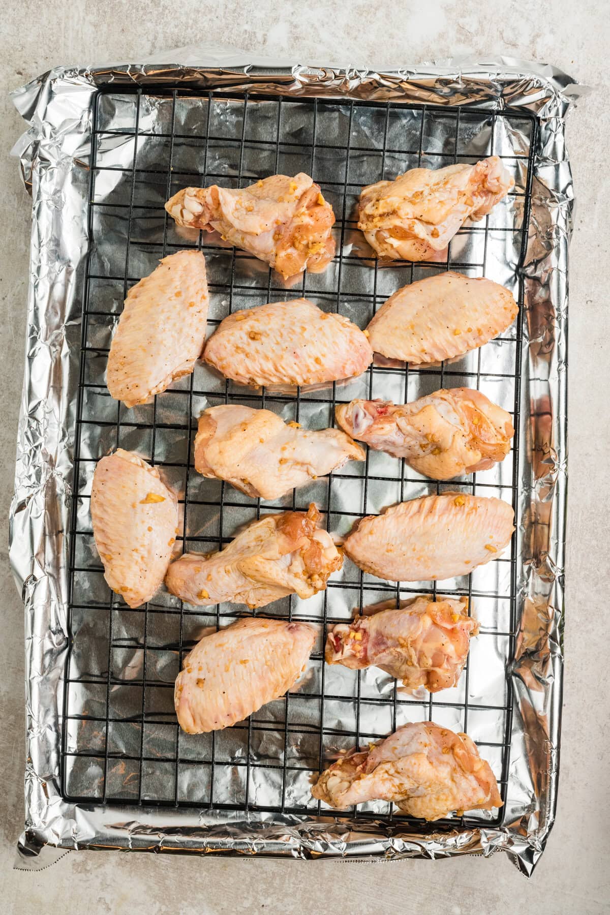 Wings on a rack on a baking sheet. 
