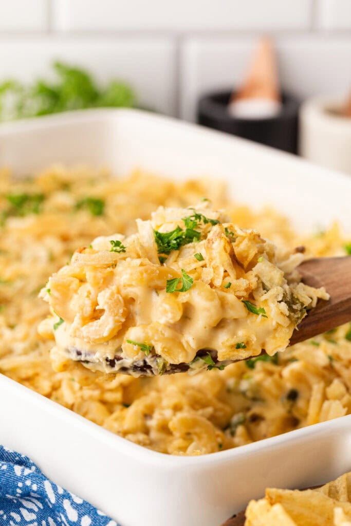 Poblano mac and cheese on a spoon over the casserole.