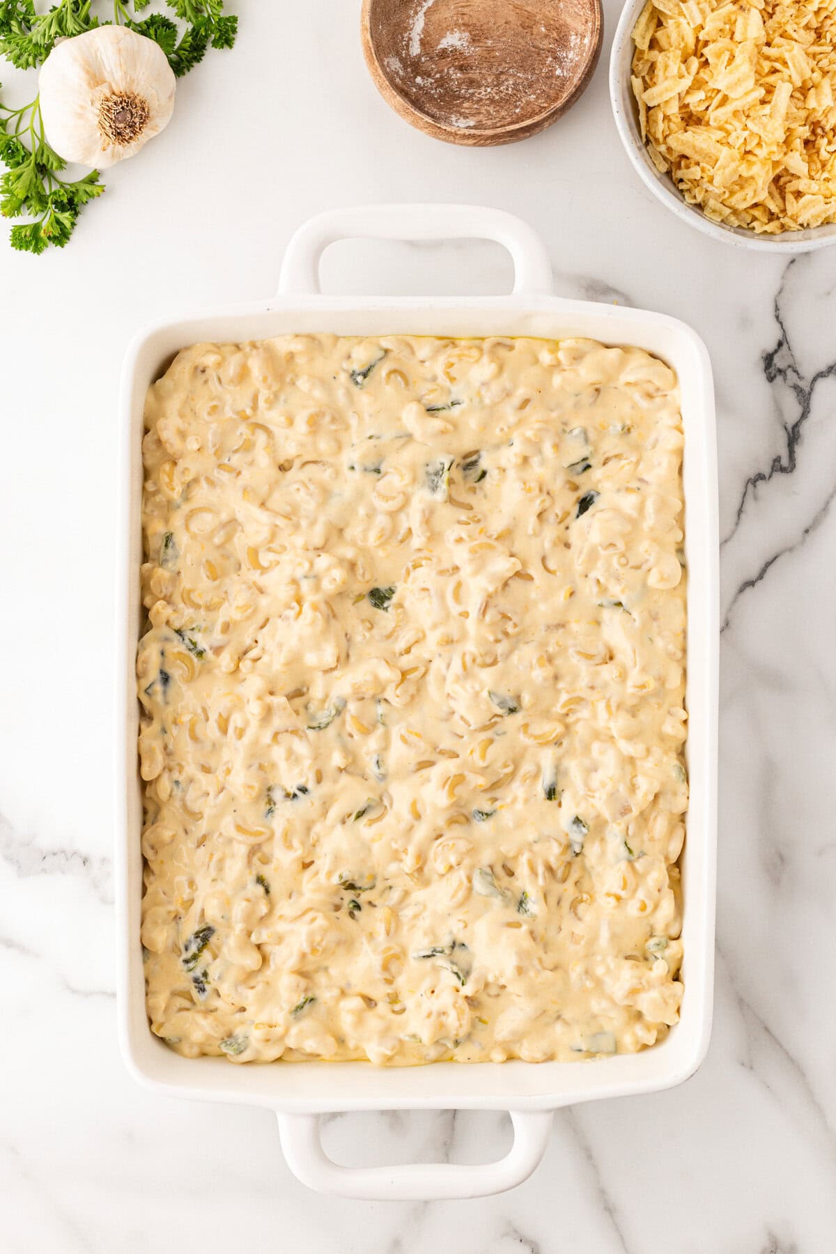 Adding mac and cheese to the casserole. 
