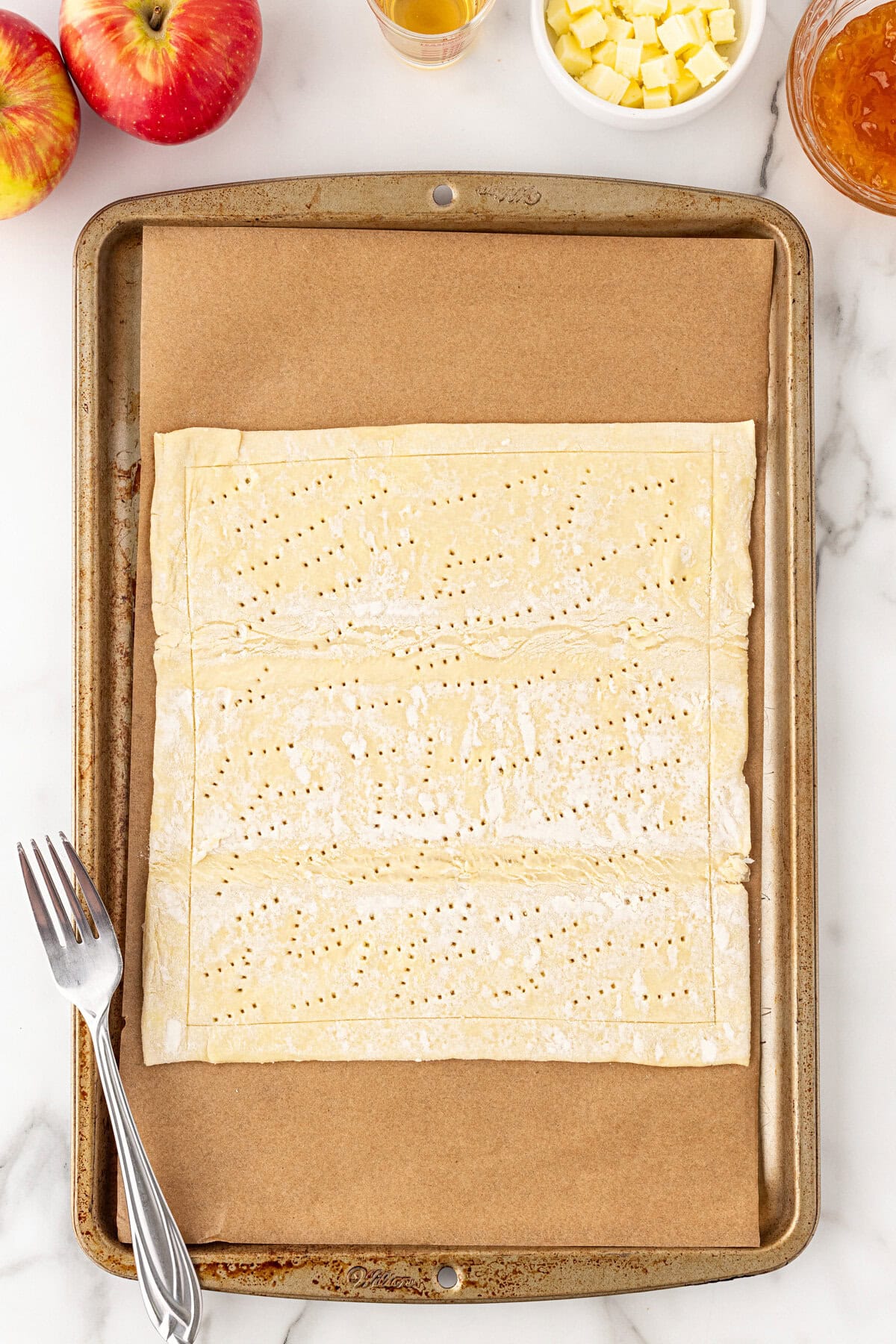 Poking the pastry with a fork.