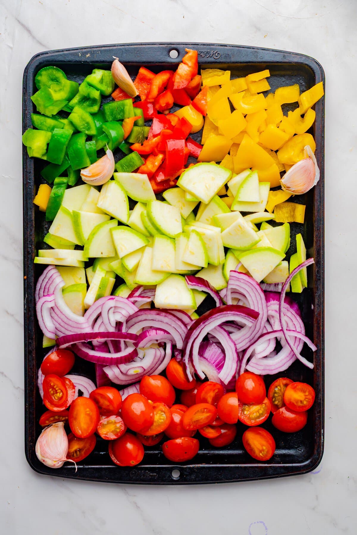 Cut veggies ona baking sheet.