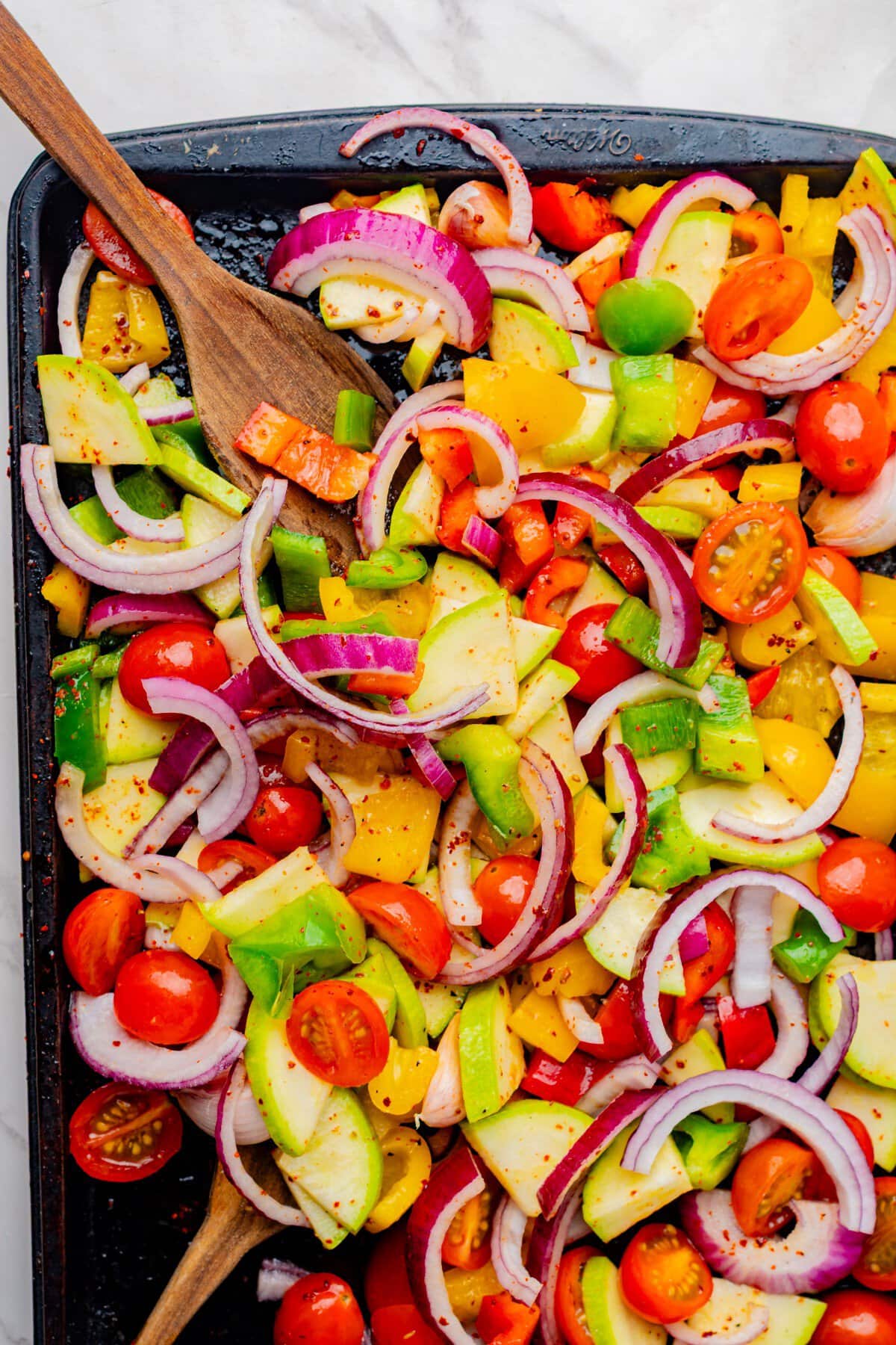 Mixing the veggies as they roast.
