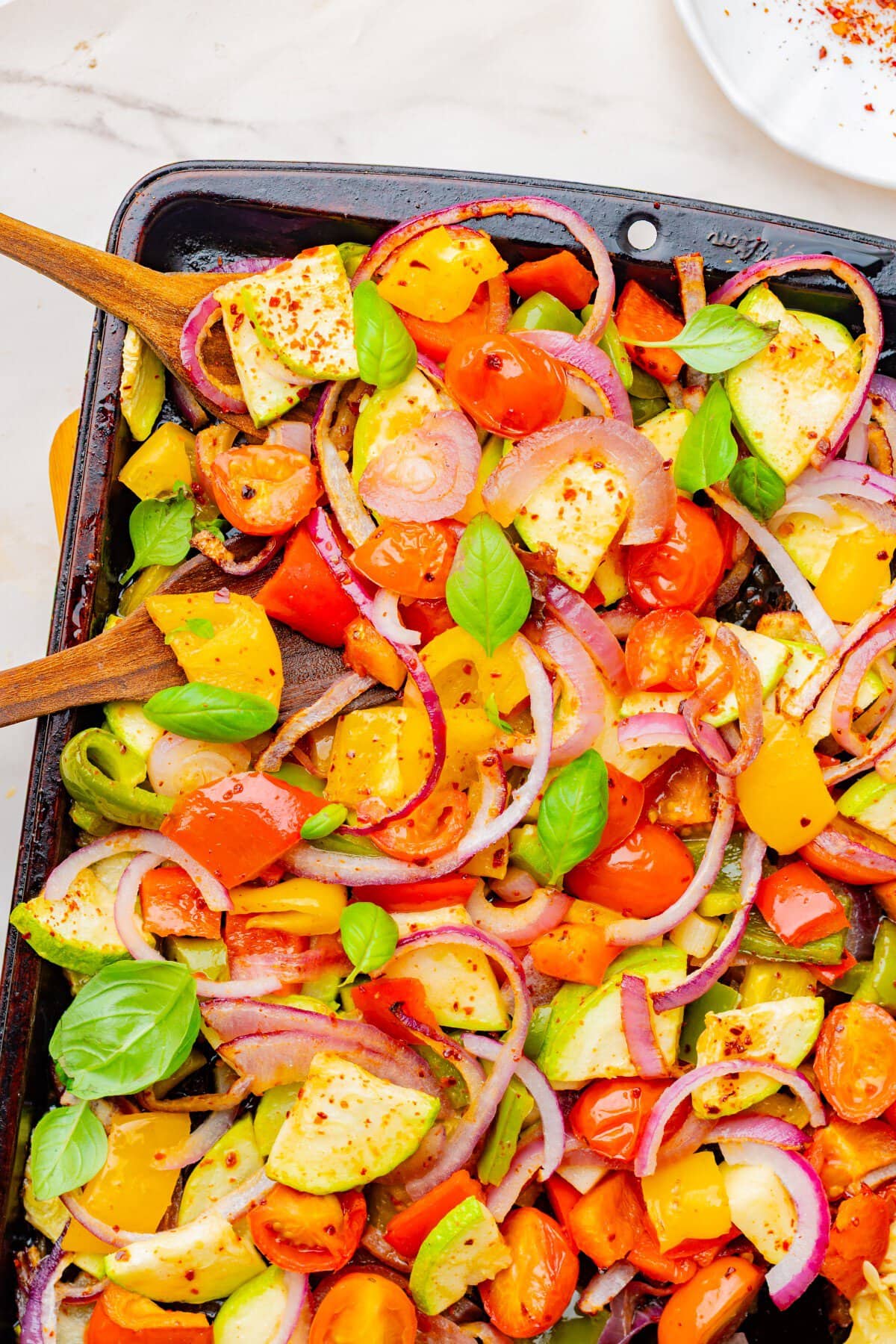 Roasted veggies garnished with fresh basil.