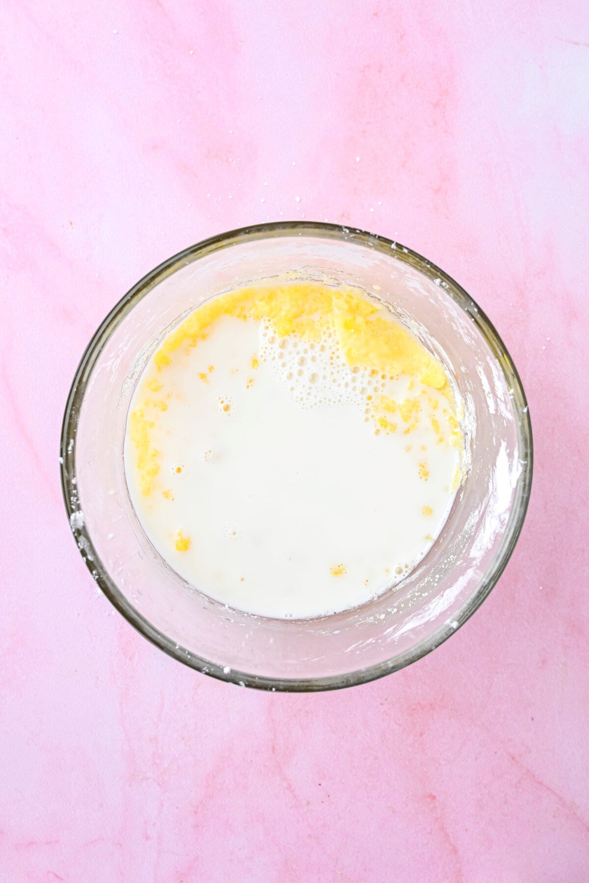 Heated milk added to the egg mixture.