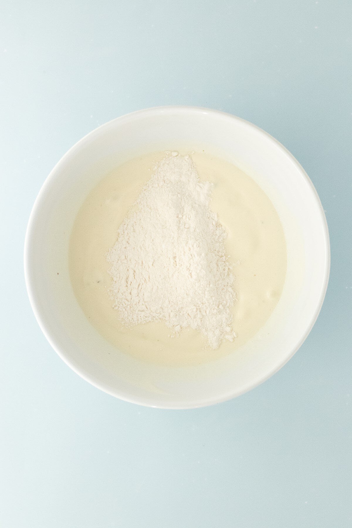 Flour and melted ice cream in a bowl.
